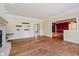 Sun-filled living room with hardwood floors, custom shelving, and open access to other spaces at 6345 Canak Dr, Avon, IN 46123