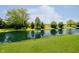 Scenic view of the lush green lawn leading down to the tranquil pond at 6345 Canak Dr, Avon, IN 46123