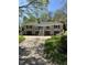 Stately stone home with a grand entrance, mature trees, and a well-maintained driveway offering curb appeal at 7030 Central Ave, Indianapolis, IN 46220
