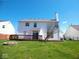 View of the back exterior with a wooden deck and a spacious yard, great for outdoor activities and relaxation at 7150 Pheasant Ridge Dr, Indianapolis, IN 46237