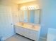 Bathroom boasts double sinks, vanity, and large mirror at 7150 Pheasant Ridge Dr, Indianapolis, IN 46237