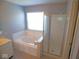 Bright bathroom features soaking tub and a glass shower at 7150 Pheasant Ridge Dr, Indianapolis, IN 46237