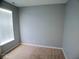 Cozy bedroom featuring neutral carpet, gray walls and a window allowing natural light at 7150 Pheasant Ridge Dr, Indianapolis, IN 46237