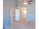 Bedroom with carpet and ceiling fan offers a view of the en suite bathroom at 7150 Pheasant Ridge Dr, Indianapolis, IN 46237