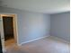 Cozy bedroom with carpet offers a view of the hallway and en suite at 7150 Pheasant Ridge Dr, Indianapolis, IN 46237