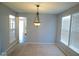 Dining area with carpet flooring and chandelier with natural light from the windows at 7150 Pheasant Ridge Dr, Indianapolis, IN 46237