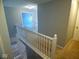 Bright hallway features neutral paint, white railing, and carpeted floors at 7150 Pheasant Ridge Dr, Indianapolis, IN 46237