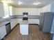 Modern kitchen with stainless steel appliances, granite countertops and ample cabinet space at 7150 Pheasant Ridge Dr, Indianapolis, IN 46237