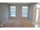 Bright living room with neutral carpet, gray walls and two windows offering natural light at 7150 Pheasant Ridge Dr, Indianapolis, IN 46237