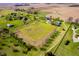 Wide aerial view of farmland and houses, featuring green fields and distant treelines at 7371 E 100 N, Whitestown, IN 46075