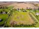 Expansive aerial view of a property featuring a large lot, farmhouse-style home, and agricultural fields at 7371 E 100 N, Whitestown, IN 46075