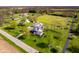 Aerial view of a sprawling property with a well-manicured lawn, mature trees, and various buildings at 7371 E 100 N, Whitestown, IN 46075