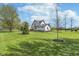 Expansive green backyard with mature trees and plenty of space to enjoy at 7371 E 100 N, Whitestown, IN 46075