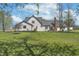 Expansive backyard featuring lush green lawn, mature trees, and the rear of a white two-story home at 7371 E 100 N, Whitestown, IN 46075