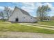 Barn exterior with long gravel driveway, siding, and metal roof at 7371 E 100 N, Whitestown, IN 46075