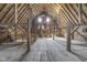 Rustic barn interior featuring exposed wood beams, weathered wood plank flooring, and natural light from windows at 7371 E 100 N, Whitestown, IN 46075
