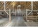 Open barn interior with wooden beams and flooring and some storage at 7371 E 100 N, Whitestown, IN 46075