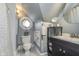 Compact bathroom featuring stylish fixtures, a vanity, and a unique window at 7371 E 100 N, Whitestown, IN 46075