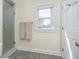 Bright bathroom featuring glass shower, light walls, and a window with natural light at 7371 E 100 N, Whitestown, IN 46075
