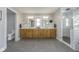 Bright bathroom featuring double vanities, granite countertops, and tiled walk-in shower at 7371 E 100 N, Whitestown, IN 46075