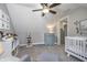 Bedroom with vaulted ceiling, crib, soft chair, and decor at 7371 E 100 N, Whitestown, IN 46075