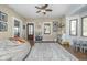 Inviting bonus room boasts stylish ceiling fan, comfortable seating, and natural light at 7371 E 100 N, Whitestown, IN 46075
