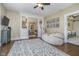 Inviting bonus room boasts stylish ceiling fan, comfortable seating, and natural light at 7371 E 100 N, Whitestown, IN 46075