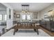 An elegant dining room with a rustic wood table, bench, chairs, chandelier, and buffet at 7371 E 100 N, Whitestown, IN 46075