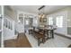 An elegant dining room with wood table, bench, chairs, chandelier, and access to the stairs at 7371 E 100 N, Whitestown, IN 46075