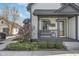 Inviting front porch with seating and blooming magnolia tree at 7371 E 100 N, Whitestown, IN 46075