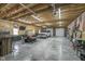 Well-lit garage featuring exposed beams, truck parking, and a lounge area at 7371 E 100 N, Whitestown, IN 46075