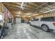 Spacious garage with exposed beams, a large truck, and ample shelving at 7371 E 100 N, Whitestown, IN 46075