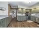 Kitchen with shaker cabinets, stainless appliances, wooden floors, and ample counter space at 7371 E 100 N, Whitestown, IN 46075