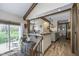 Open-concept kitchen featuring wooden beams, breakfast bar, and stainless steel appliances at 7371 E 100 N, Whitestown, IN 46075