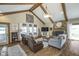 Cozy living room with vaulted ceilings, exposed beams, and a stone fireplace at 7371 E 100 N, Whitestown, IN 46075