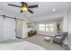 Bright main bedroom with a king bed, rocking chair, and barn door access at 7371 E 100 N, Whitestown, IN 46075