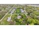 An aerial view of a home with a manicured lawn, mature trees, and surrounding neighborhood at 7440 Graham Rd, Indianapolis, IN 46250