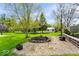 Expansive backyard with lush lawn and inviting fire pit area at 7440 Graham Rd, Indianapolis, IN 46250