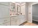 Bathroom with double sinks, white cabinets, neutral countertops, and ample storage space at 7440 Graham Rd, Indianapolis, IN 46250