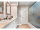 Bathroom featuring double vanity, neutral countertops, a walk-in shower, and ample storage space at 7440 Graham Rd, Indianapolis, IN 46250