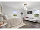 Bright bedroom with neutral tones, comfortable seating area, and large windows offering outside views at 7440 Graham Rd, Indianapolis, IN 46250