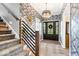 Elegant foyer with stylish wallpaper, modern lighting, and a view of the front door at 7440 Graham Rd, Indianapolis, IN 46250