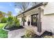 Inviting front porch featuring stone accents, lush landscaping, and a stylish front door at 7440 Graham Rd, Indianapolis, IN 46250