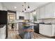 This bright eat-in kitchen features white cabinets, a gray island with seating, and updated appliances at 7440 Graham Rd, Indianapolis, IN 46250