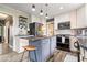 This bright kitchen features white cabinets, a gray island with seating, and updated appliances at 7440 Graham Rd, Indianapolis, IN 46250