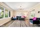 Bright and airy living room featuring large windows, stylish decor, and modern flooring at 7440 Graham Rd, Indianapolis, IN 46250