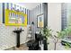 Striking powder room with striped wallpaper, bright yellow mirror, and modern fixtures at 7440 Graham Rd, Indianapolis, IN 46250