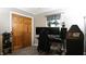 This bedroom includes a personal computer, dark curtains, and a wooden paneled closet at 8035 Black Oak Ct, Plainfield, IN 46168