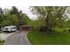 An aerial view showing the home, garage, RV, and driveway surrounded by lush greenery at 8035 Black Oak Ct, Plainfield, IN 46168