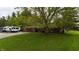 Charming house with a beautiful lawn, many trees, and a trailer in the driveway at 8035 Black Oak Ct, Plainfield, IN 46168